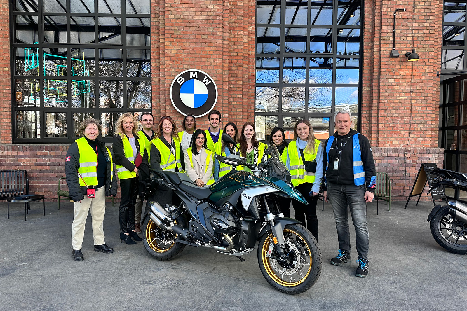 LSU students pose with a motorcycle and BMW employees outside the BMW Group Motorradwerk in Berlin.