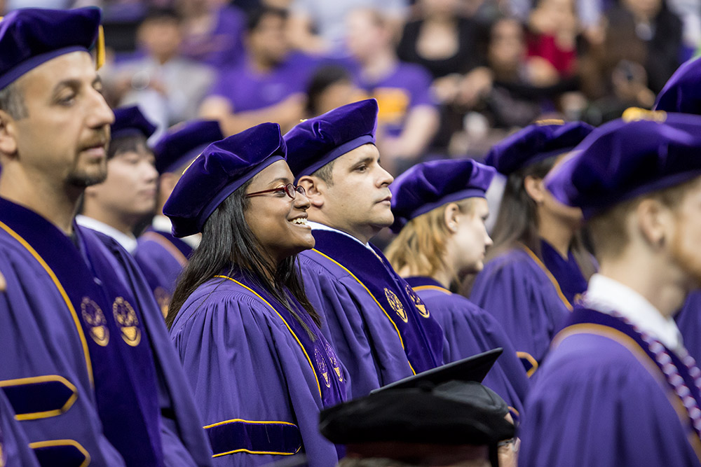 PhD candidates standing at a graduation ceremony